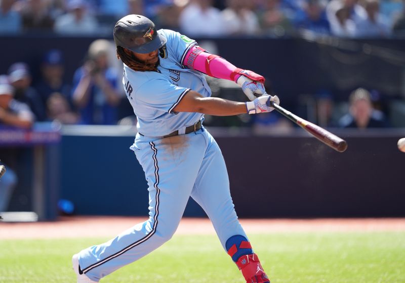 Aug 30, 2023; Toronto, Ontario, CAN; Toronto Blue Jays first baseman Vladimir Guerrero Jr. (27) hits a single against the Washington Nationals during the first inning at Rogers Centre. Mandatory Credit: Nick Turchiaro-USA TODAY Sports