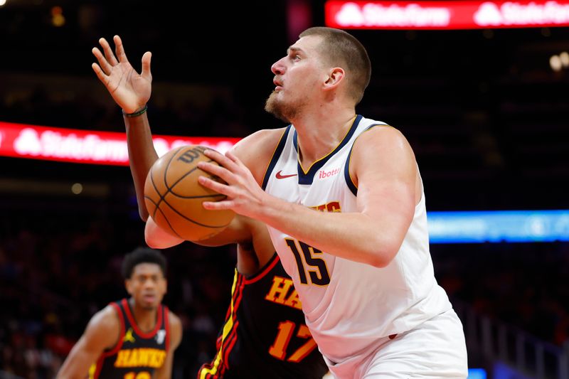 ATLANTA, GEORGIA - DECEMBER 08: Nikola Jokic #15 of the Denver Nuggets drives drives to the basket during the first quarter against the Atlanta Hawks at State Farm Arena on December 8, 2024 in Atlanta, Georgia. NOTE TO USER: User expressly acknowledges and agrees that, by downloading and or using this photograph, User is consenting to the terms and conditions of the Getty Images License Agreement. (Photo by Todd Kirkland/Getty Images)