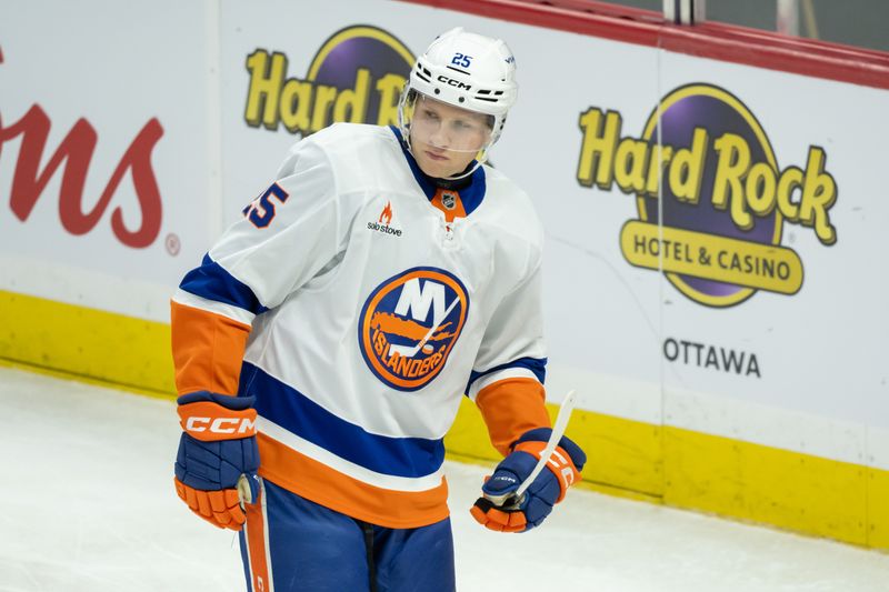 Dec 8, 2024; Ottawa, Ontario, CAN; New York Islanders defenseman Dennis Cholowski (25) skates in the third period against the Ottawa Senators at the Canadian Tire Centre. Mandatory Credit: Marc DesRosiers-Imagn Images