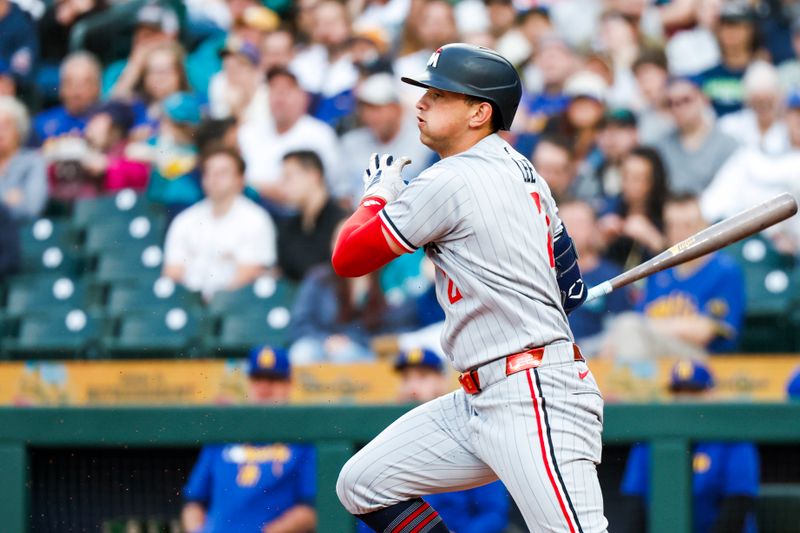 May 30, 2025; Seattle, Washington, USA; Minnesota Twins second baseman Brooks Lee (2) hits an RBI-fielders choice against the Seattle Mariners during the fourth inning at T-Mobile Park. Mandatory Credit: Joe Nicholson-Imagn Images