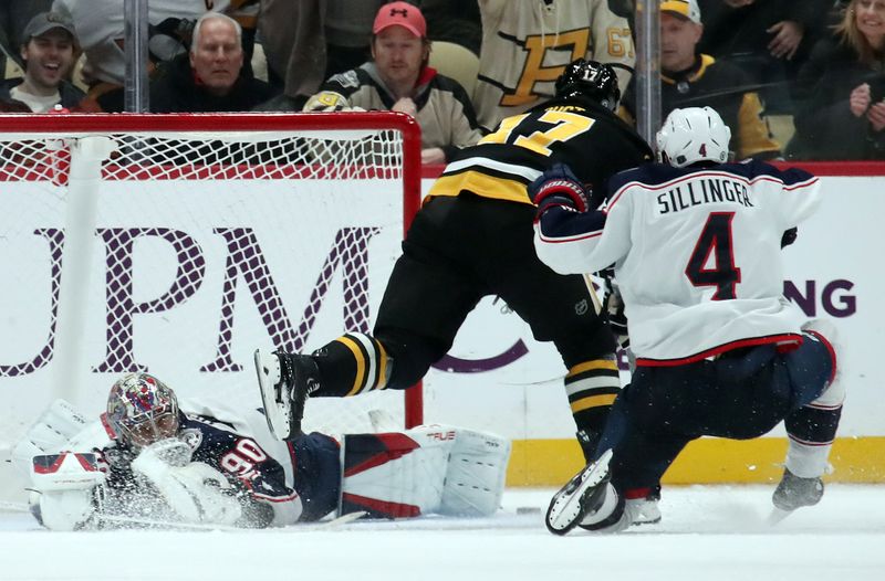 Jan 7, 2025; Pittsburgh, Pennsylvania, USA; Columbus Blue Jackets goaltender Elvis Merzlikins (90) makes a save against Pittsburgh Penguins right wing Bryan Rust (17) as Blue Jackets center Cole Sillinger (4) defends in overtime at PPG Paints Arena. Mandatory Credit: Charles LeClaire-Imagn Images