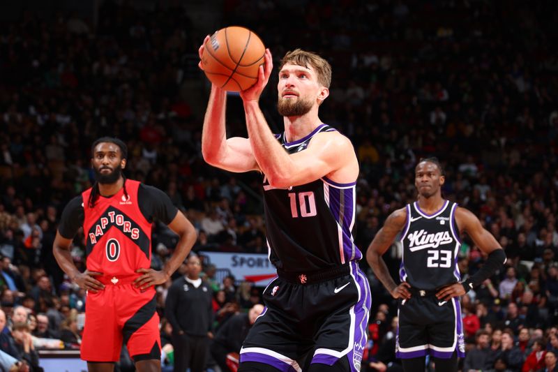 TORONTO, CANADA - MARCH 20:Domantas Sabonis #10 of the Sacramento Kings shoots a free throw during the game against the Toronto Raptors  on March 20, 2024 at the Scotiabank Arena in Toronto, Ontario, Canada.  NOTE TO USER: User expressly acknowledges and agrees that, by downloading and or using this Photograph, user is consenting to the terms and conditions of the Getty Images License Agreement.  Mandatory Copyright Notice: Copyright 2024 NBAE (Photo by Vaughn Ridley/NBAE via Getty Images)