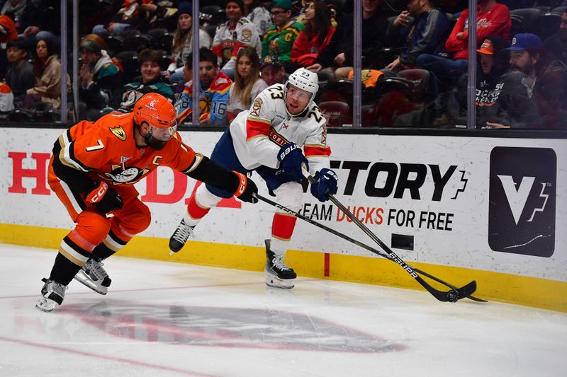 Jan 21, 2025; Anaheim, California, USA; Florida Panthers center Carter Verhaeghe (23) moves the puck against Anaheim Ducks defenseman Radko Gudas (7) during the third period at Honda Center. Mandatory Credit: Gary A. Vasquez-Imagn Images
