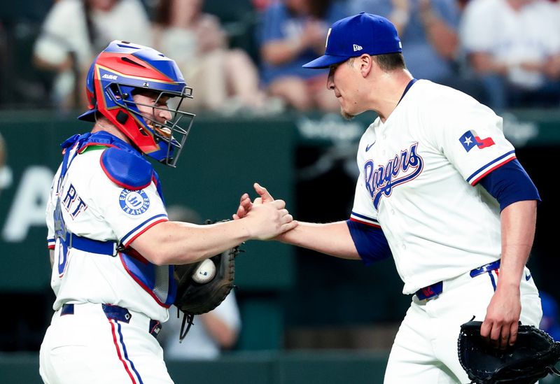 May 27, 2025; Arlington, Texas, USA; Texas Rangers relief pitcher Robert Garcia (62) celebrates with Texas Rangers catcher Tucker Barnhart (18) after the game against the Toronto Blue Jays at Globe Life Field. Mandatory Credit: Kevin Jairaj-Imagn Images