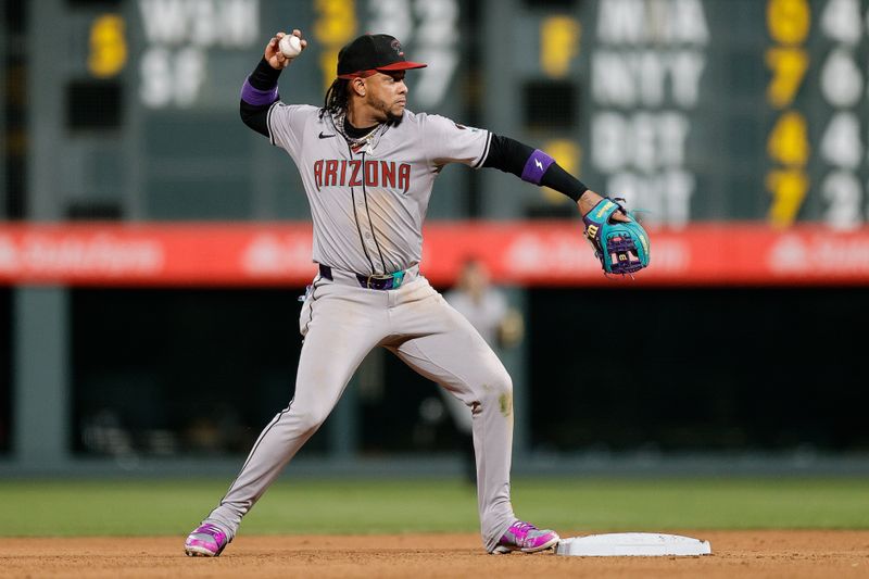 Apr 8, 2024; Denver, Colorado, USA; Arizona Diamondbacks second baseman Ketel Marte (4) turns the first half of a double play in the seventh inning against the Colorado Rockies at Coors Field. Mandatory Credit: Isaiah J. Downing-USA TODAY Sports