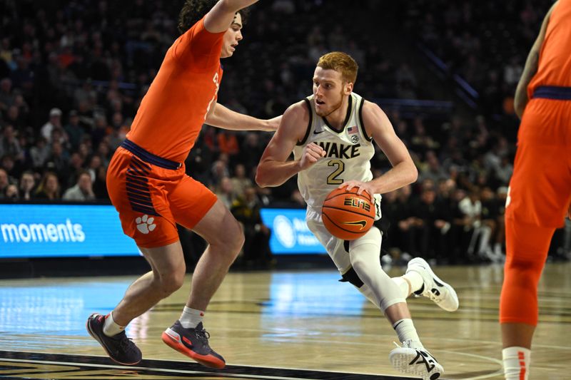 Jan 17, 2023; Winston-Salem, North Carolina, USA; Wake Forest Demon Deacons guard Cameron Hildreth (2) drives to the basket past Clemson Tigers forward Ian Schieffelin (4) during the first half at Lawrence Joel Veterans Memorial Coliseum. Mandatory Credit: William Howard-USA TODAY Sports