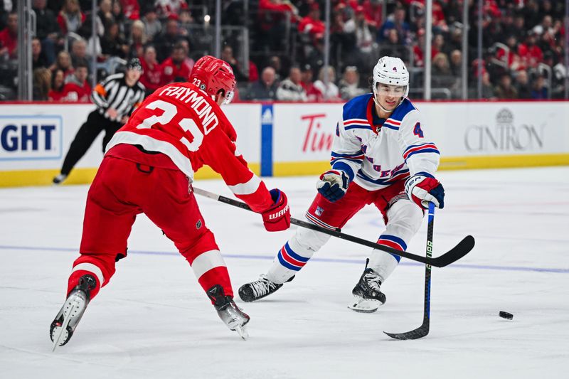 Apr 5, 2024; Detroit, Michigan, USA; New York Rangers defenseman Braden Schneider (4) and Detroit Red Wings left wing Lucas Raymond (23) battle for the puck during the third period at Little Caesars Arena. Mandatory Credit: Tim Fuller-USA TODAY Sports