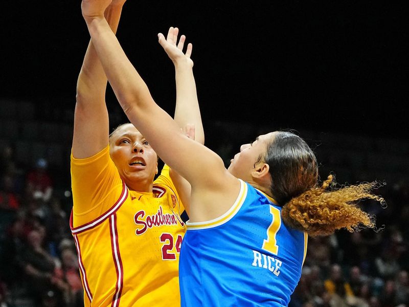 Mar 8, 2024; Las Vegas, NV, USA; USC Trojans forward Kaitlyn Davis (24) blocks a shot attempt by UCLA Bruins guard Kiki Rice (1) during the second quarter at MGM Grand Garden Arena. Mandatory Credit: Stephen R. Sylvanie-USA TODAY Sports