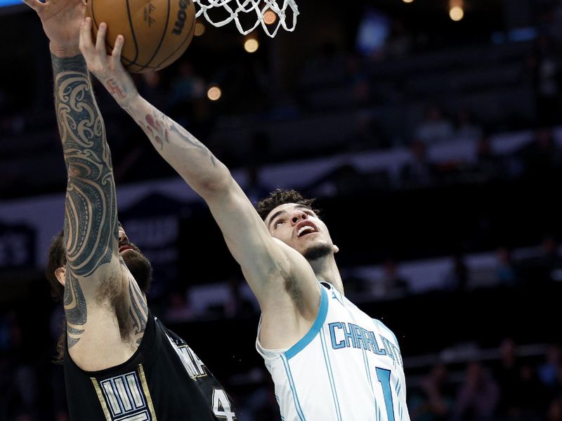 CHARLOTTE, NORTH CAROLINA - JANUARY 04: LaMelo Ball #1 of the Charlotte Hornets drives to the basket against Steven Adams #4 of the Memphis Grizzlies during the first quarter of the game at Spectrum Center on January 04, 2023 in Charlotte, North Carolina. NOTE TO USER: User expressly acknowledges and agrees that, by downloading and or using this photograph, User is consenting to the terms and conditions of the Getty Images License Agreement. (Photo by Jared C. Tilton/Getty Images)