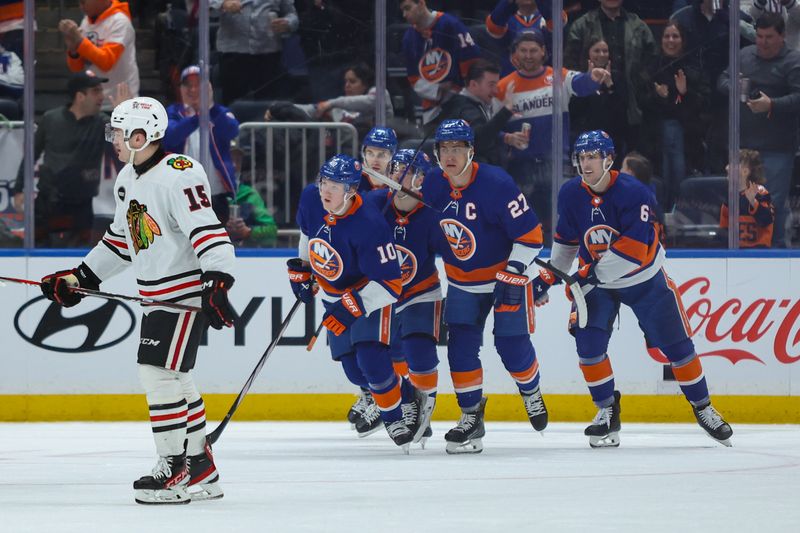 Apr 2, 2024; Elmont, New York, USA; New York Islanders right wing Simon Holmstrom (10) celebrates his goal against the Chicago Blackhawks during the third period at UBS Arena. Mandatory Credit: Thomas Salus-USA TODAY Sports