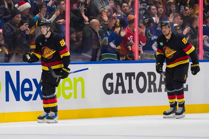 Dec 23, 2023; Vancouver, British Columbia, CAN; Vancouver Canucks forward Nils Aman (88) and forward Dakota Joshua (81) celebrate Aman   s goal against the San Jose Sharks in the second period at Rogers Arena. Mandatory Credit: Bob Frid-USA TODAY Sports