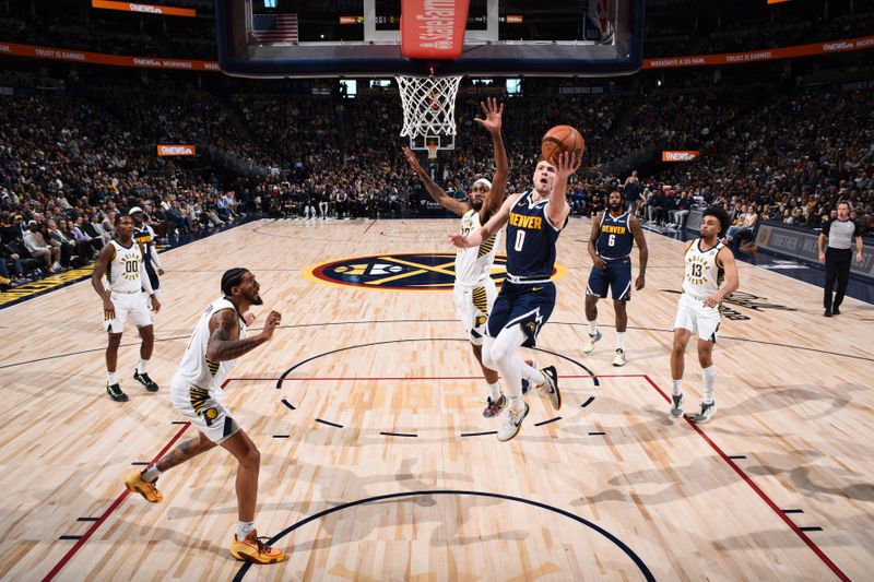 DENVER, CO - JANUARY 14: Christian Braun #0 of the Denver Nuggets drives to the basket during the game against the Indiana Pacers on January 14, 2024 at the Ball Arena in Denver, Colorado. NOTE TO USER: User expressly acknowledges and agrees that, by downloading and/or using this Photograph, user is consenting to the terms and conditions of the Getty Images License Agreement. Mandatory Copyright Notice: Copyright 2024 NBAE (Photo by Garrett Ellwood/NBAE via Getty Images)