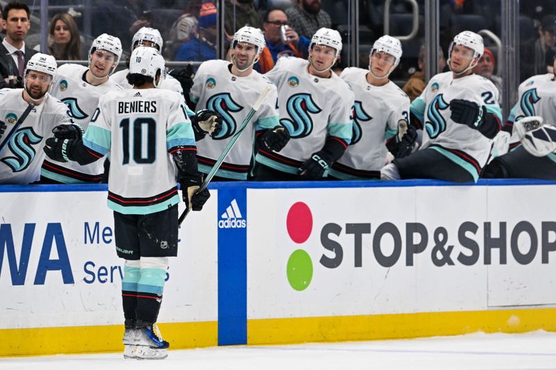 Feb 13, 2024; Elmont, New York, USA; Seattle Kraken center Matty Beniers (10) celebrates his goal against the New York Islanders with the Seattle Kraken bench during the first period at UBS Arena. Mandatory Credit: Dennis Schneidler-USA TODAY Sports