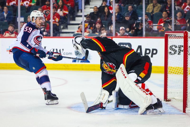 Jan 25, 2024; Calgary, Alberta, CAN; Calgary Flames goaltender Jacob Markstrom (25) makes a save against Columbus Blue Jackets right wing Yegor Chinakhov (59) during the second period at Scotiabank Saddledome. Mandatory Credit: Sergei Belski-USA TODAY Sports