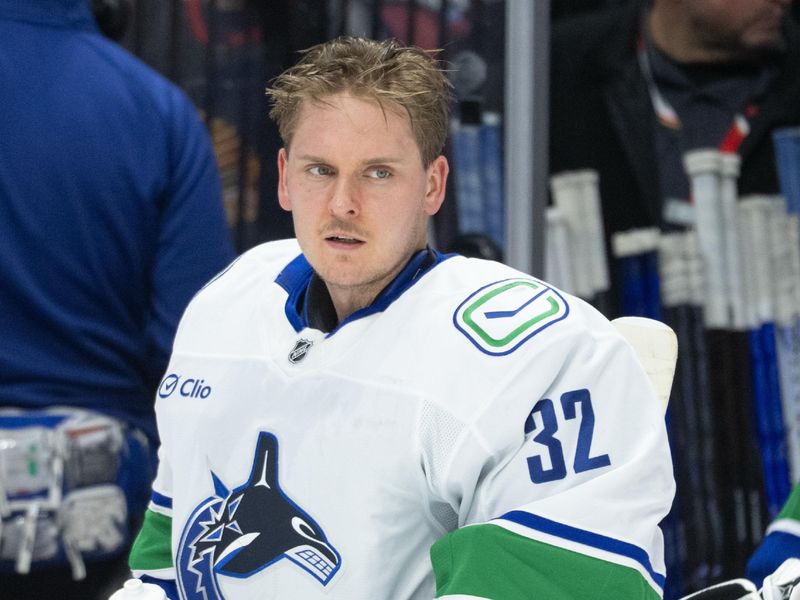 Jan 13, 2026; Ottawa, Ontario, CAN; Vancouver Canucks goalie Kevin Lankinen (32) during a break in the first period against the Ottawa Senators at the Canadian Tire Centre. Mandatory Credit: Marc DesRosiers-IMAGN Images