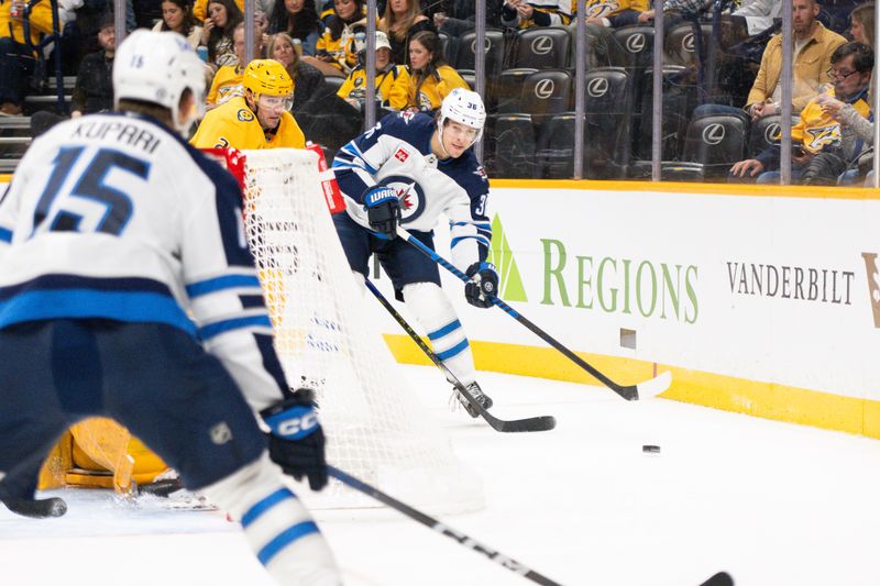 Nov 23, 2024; Nashville, Tennessee, USA; Winnipeg Jets center Morgan Barron (36) passes the puck against the Nashville Predators during the second period at Bridgestone Arena. Mandatory Credit: Steve Roberts-Imagn Images