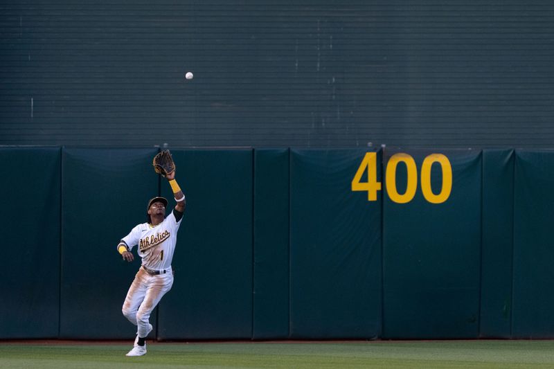 Jun 14, 2023; Oakland, California, USA;  Oakland Athletics center fielder Esteury Ruiz (1) catches the ball during the fifth inning against the Tampa Bay Rays at Oakland-Alameda County Coliseum. Mandatory Credit: Stan Szeto-USA TODAY Sports