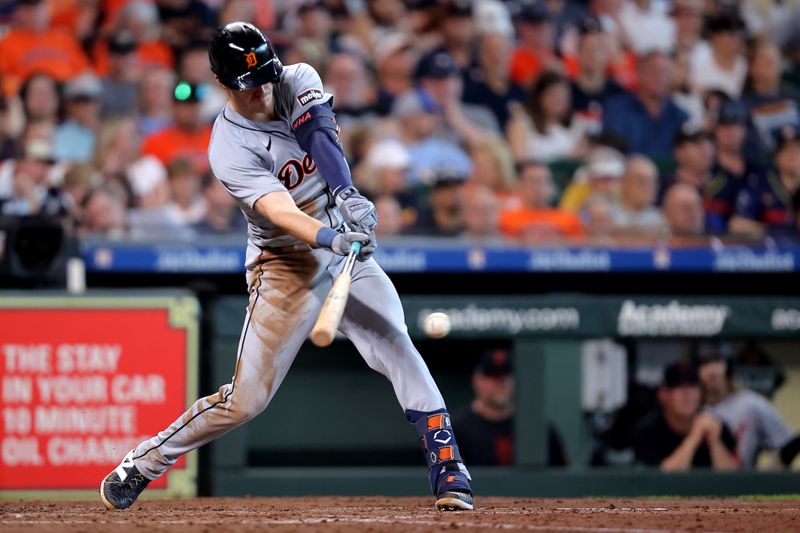 Jun 15, 2024; Houston, Texas, USA; Detroit Tigers first baseman Mark Canha (21) hits an RBI single to right field against the Houston Astros during the third inning at Minute Maid Park. Mandatory Credit: Erik Williams-USA TODAY Sports