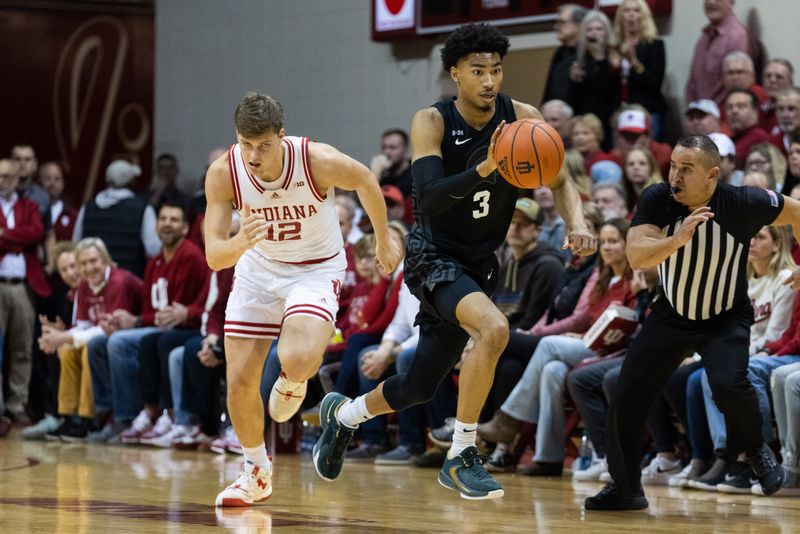 Jan 22, 2023; Bloomington, Indiana, USA; Michigan State Spartans guard Jaden Akins (3) dribbles the ball while Indiana Hoosiers forward Miller Kopp (12) defends in the second half at Simon Skjodt Assembly Hall. Mandatory Credit: Trevor Ruszkowski-USA TODAY Sports