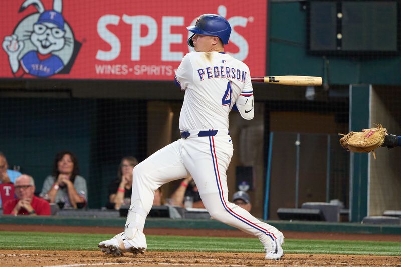 Sep 10, 2025; Arlington, Texas, USA; Texas Rangers designated hitter Joc Pederson (4) follows through on his RBI single against the Milwaukee Brewers during the third inning at Globe Life Field. Mandatory Credit: Jim Cowsert-Imagn Images