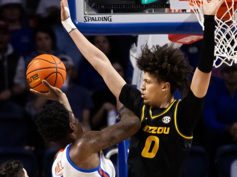 Feb 28, 2024; Gainesville, Florida, USA; Missouri Tigers forward Jordan Butler (0) attempts to block a shot from Florida Gators forward Tyrese Samuel (4) during the first half at Exactech Arena at the Stephen C. O'Connell Center. Mandatory Credit: Matt Pendleton-USA TODAY Sports