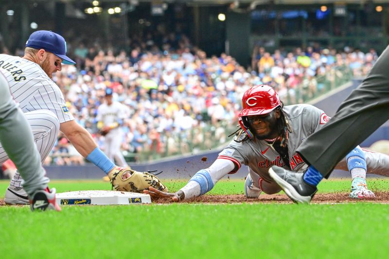 Jun 16, 2024; Milwaukee, Wisconsin, USA; Cincinnati Reds shortstop Elly De La Cruz (44) gets back to first base before tag by Milwaukee Brewers  first baseman Jake Bauers (9) on a pickoff attempt in the third inning at American Family Field. Mandatory Credit: Benny Sieu-USA TODAY Sports