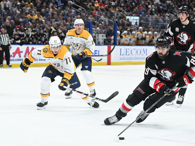 Jan 31, 2025; Buffalo, New York, USA; Buffalo Sabres right wing Alex Tuch (89) keeps the puck from Nashville Predators right wing Luke Evangelista (77) in the first period at the KeyBank Center. Mandatory Credit: Mark Konezny-Imagn Images