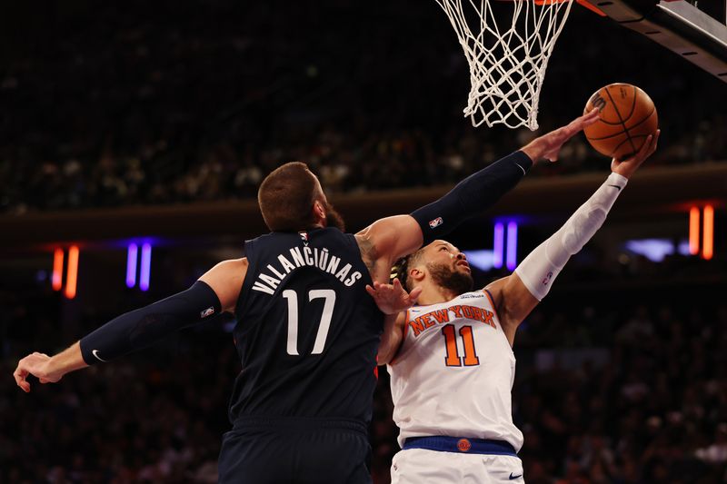 NEW YORK, NEW YORK - NOVEMBER 18: Jalen Brunson #11 of the New York Knicks goes to the basket as Jonas Valanciunas #17 of the Washington Wizards defends during the second half at Madison Square Garden on November 18, 2024 in New York City. NOTE TO USER: User expressly acknowledges and agrees that, by downloading and or using this photograph, User is consenting to the terms and conditions of the Getty Images License Agreement. (Photo by Sarah Stier/Getty Images)