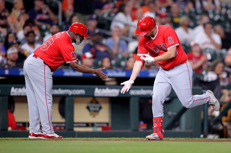 May 20, 2024; Houston, Texas, USA; Los Angeles Angels first baseman Nolan Schanuel (18) is congratulated by Los Angeles Angels third base coach Eric Young Sr. (85) after hitting a three-run home run against the Houston Astros during the fifth inning at Minute Maid Park. Mandatory Credit: Erik Williams-USA TODAY Sports