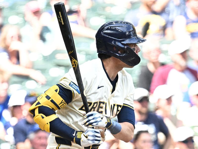 Jun 12, 2024; Milwaukee, Wisconsin, USA; Milwaukee Brewers outfielder Christian Yelich (22) gets a base hit against the Toronto Blue Jays in the sixth inning at American Family Field. Mandatory Credit: Michael McLoone-USA TODAY Sports