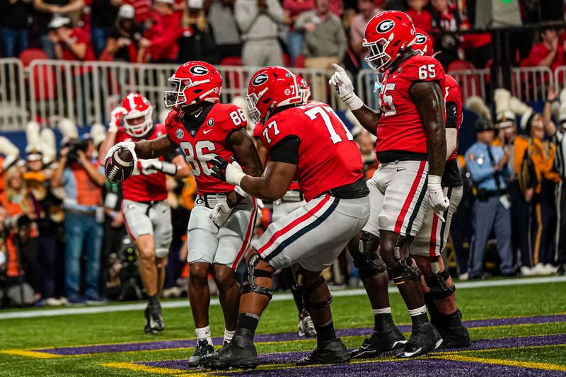 Dec 3, 2022; Atlanta, GA, USA; Georgia Bulldogs players react with wide receiver Dillon Bell (86) after he caught a touchdown pass against the LSU Tigers at Mercedes-Benz Stadium. Mandatory Credit: Dale Zanine-USA TODAY Sports