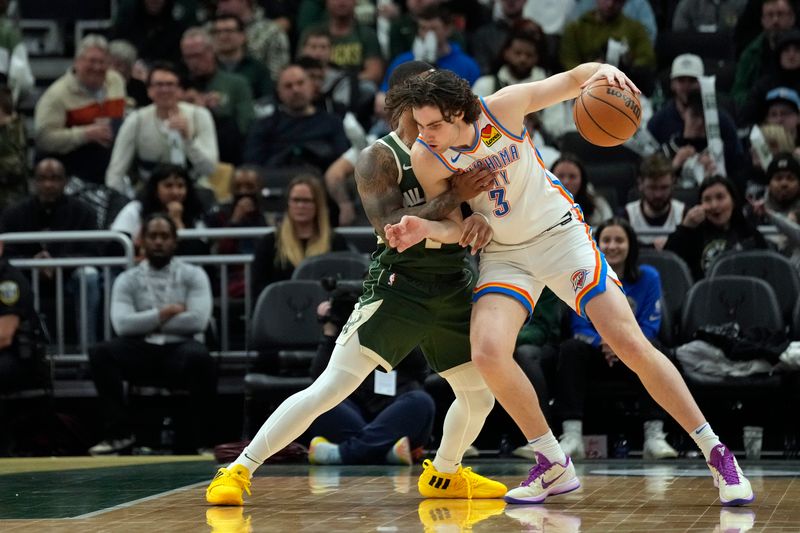 MILWAUKEE, WISCONSIN - MARCH 24: Josh Giddey #3 of the Oklahoma City Thunder drives against Damian Lillard #0 of the Milwaukee Bucks during the second half at Fiserv Forum on March 24, 2024 in Milwaukee, Wisconsin. NOTE TO USER: User expressly acknowledges and agrees that, by downloading and or using this photograph, User is consenting to the terms and conditions of the Getty Images License Agreement. (Photo by Patrick McDermott/Getty Images)