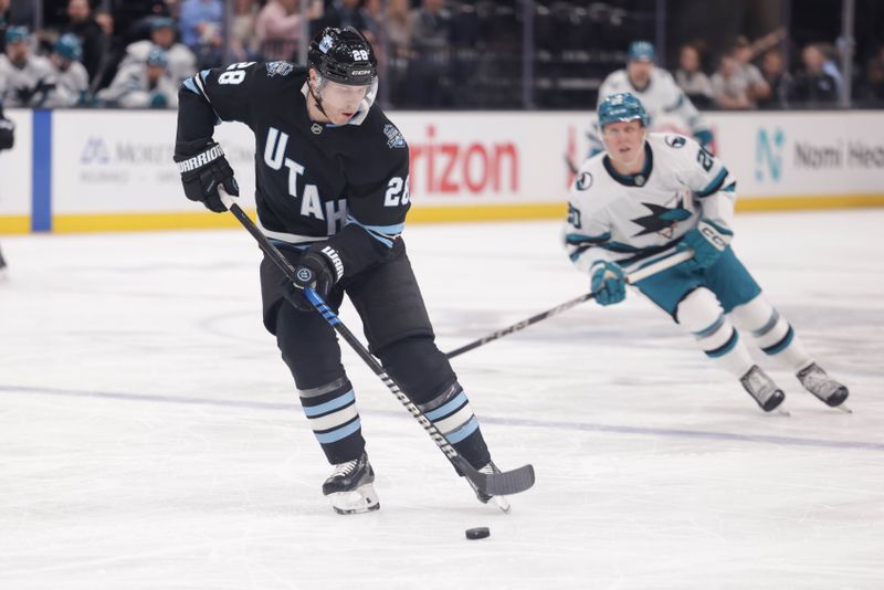 Oct 28, 2024; Salt Lake City, Utah, USA;  Utah Hockey Club defenseman Ian Cole (28) controls the puck during the first period against the San Jose Sharks at Delta Center. Mandatory Credit: Chris Nicoll-Imagn Images