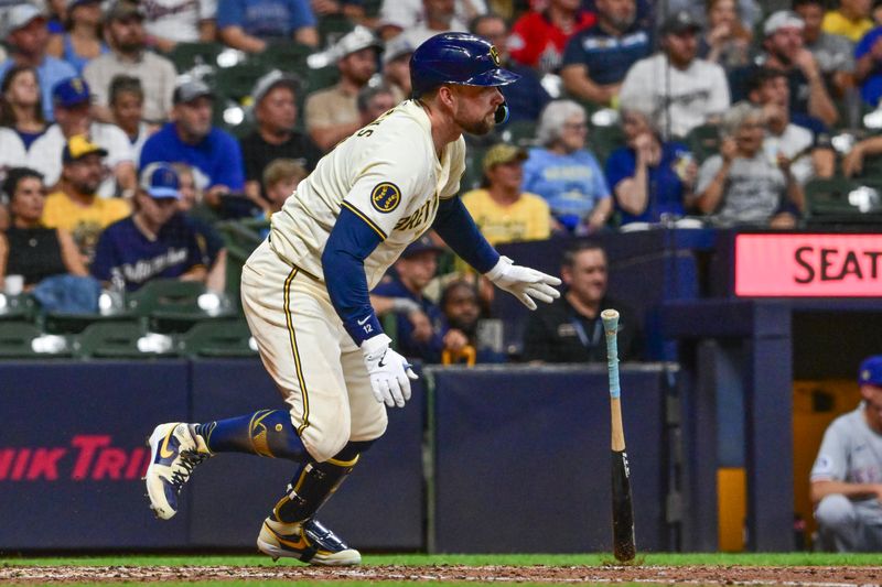 Jun 25, 2024; Milwaukee, Wisconsin, USA; Milwaukee Brewers designated hitter Rhys Hoskins (12) hits an RBI single against the Texas Rangers in the seventh inning at American Family Field. Mandatory Credit: Benny Sieu-USA TODAY Sports