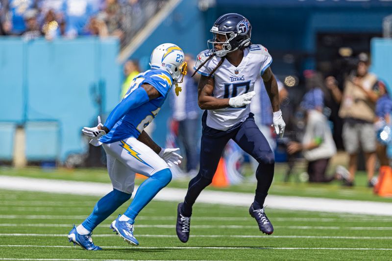 Tennessee Titans wide receiver DeAndre Hopkins (10) looks back for a pass as he's defended by Los Angeles Chargers cornerback J.C. Jackson (27) during their NFL football game Sunday, Sept. 17, 2023, in Nashville, Tenn. (AP Photo/Wade Payne)