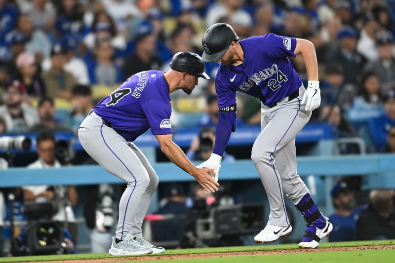 Sep 21, 2024; Los Angeles, California, USA; Colorado Rockies third baseman Ryan McMahon (24) high fives third base coach/infield coach Warren Schaeffer (34) after hitting a home run against the Los Angeles Dodgers during the fifth inning at Dodger Stadium. Mandatory Credit: Jonathan Hui-Imagn Images