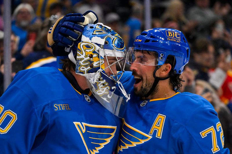 Oct 19, 2024; St. Louis, Missouri, USA;  St. Louis Blues defenseman Justin Faulk (72) and goaltender Joel Hofer (30) celebrate after the Blues defeated the Carolina Hurricanes at Enterprise Center. Mandatory Credit: Jeff Curry-Imagn Images