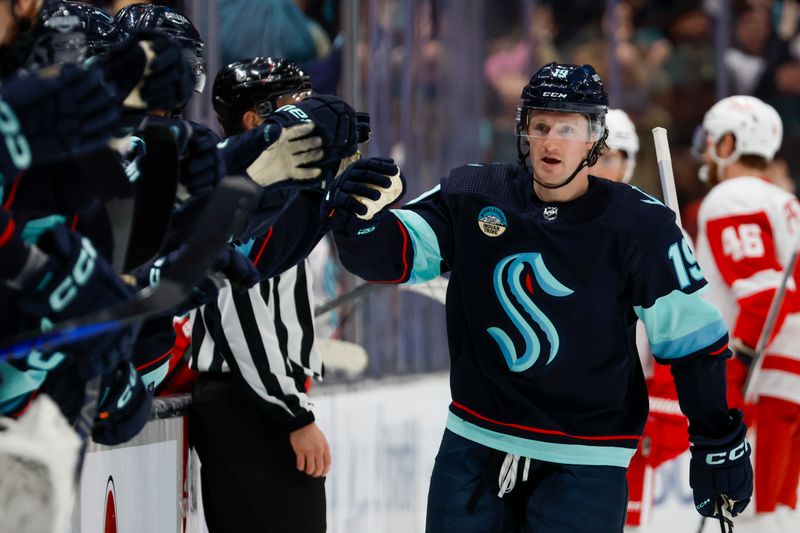 Feb 19, 2024; Seattle, Washington, USA; Seattle Kraken left wing Jared McCann (19) celebrates after scoring a power play goal against the Detroit Red Wings during the first period at Climate Pledge Arena. Mandatory Credit: Joe Nicholson-USA TODAY Sports