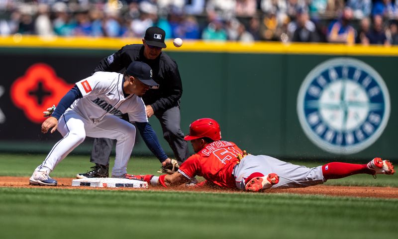 Apr 30, 2025; Seattle, Washington, USA;  Los Angeles Angels left fielder Gustavo Campero (51) steals second base as Seattle Mariners Leo Rivas (76) cannot hold on to the ball during the second inning at T-Mobile Park. Mandatory Credit: Stephen Brashear-Imagn Images