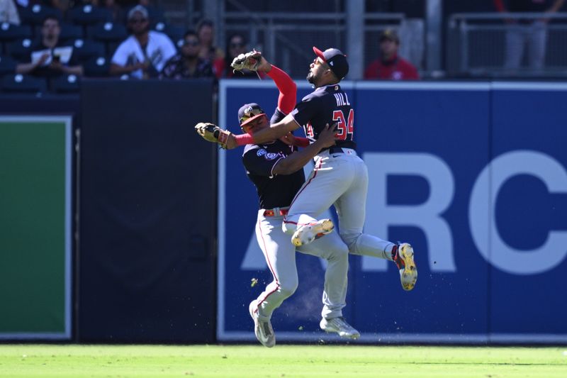 Jun 25, 2023; San Diego, California, USA; Washington Nationals center fielder Derek Hill (34) collides with left fielder Stone Garrett (36) after making a game-ending catch in the ninth inning against the San Diego Padres at Petco Park. Mandatory Credit: Orlando Ramirez-USA TODAY Sports