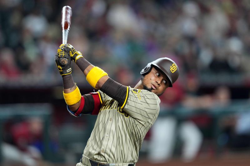 May 5, 2024; Phoenix, Arizona, USA; San Diego Padres designated hitter Luis Arraez swings at the on deck circle during the first inning against the Arizona Diamondbacks at Chase Field. Mandatory Credit: Joe Camporeale-USA TODAY Sports