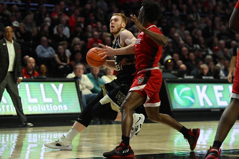 Jan 28, 2023; Winston-Salem, North Carolina, USA;    Wake Forest Demon Deacons guard Cameron Hildreth (2) drives on North Carolina State Wolfpack guard Jarkel Joiner (1) during the first half at Lawrence Joel Veterans Memorial Coliseum. Mandatory Credit: William Howard-USA TODAY Sports