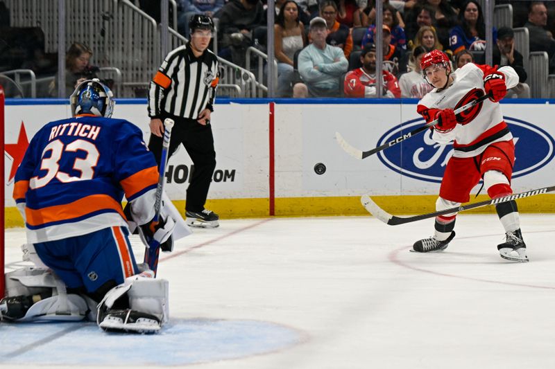 Apr 14, 2026; Elmont, New York, USA; Carolina Hurricanes left wing Bradly Nadeau (29) attempts a shot on New York Islanders goaltender David Rittich (33) during the third period at UBS Arena. Mandatory Credit: Dennis Schneidler-Imagn Images Apr 14, 2026; Elmont, New York, USA; Carolina Hurricanes left wing Bradly Nadeau (29) attempts a shot on New York Islanders goaltender David Rittich (33) during the third period at UBS Arena. Mandatory Credit: Dennis Schneidler-Imagn Images
