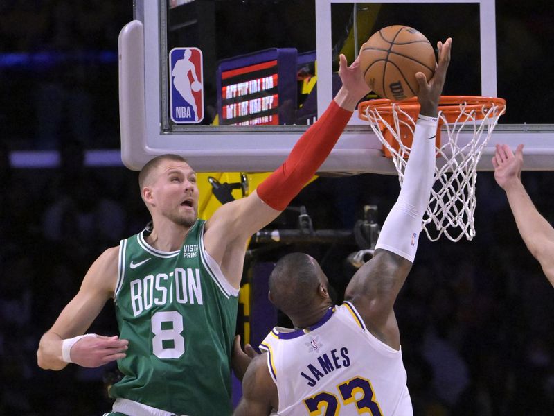 LOS ANGELES, CALIFORNIA - DECEMBER 25: Kristaps Porzingis #8 of the Boston Celtics blocks a shot by LeBron James #23 of the Los Angeles Lakers in the second half at Crypto.com Arena on December 25, 2023 in Los Angeles, California. NOTE TO USER: User expressly acknowledges and agrees that, by downloading and or using this photograph, User is consenting to the terms and conditions of the Getty Images License Agreement.(Photo by Jayne Kamin-Oncea/Getty Images)