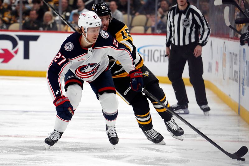 Mar 5, 2024; Pittsburgh, Pennsylvania, USA; Columbus Blue Jackets defenseman Adam Boqvist (27) moves the pic spice against Pittsburgh Penguins right wing Reilly Smith (19) during the second period at PPG Paints Arena. Mandatory Credit: Charles LeClaire-USA TODAY Sports