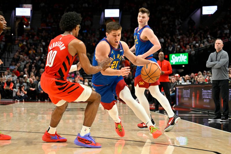 PORTLAND, OREGON - MARCH 23: Collin Gillespie #21 of the Denver Nuggets drives against Scoot Henderson #00 of the Portland Trail Blazers during the second quarter of the game at the Moda Center on March 23, 2024 in Portland, Oregon. NOTE TO USER: User expressly acknowledges and agrees that, by downloading and or using this photograph, User is consenting to the terms and conditions of the Getty Images License Agreement. (Photo by Alika Jenner/Getty Images)