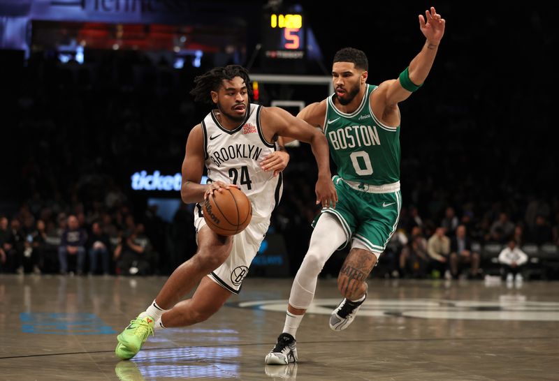 NEW YORK, NEW YORK - NOVEMBER 13: Cam Thomas #24 of the Brooklyn Nets drives against Jayson Tatum #0 of the Boston Celtics in the first half at Barclays Center on November 13, 2024 in New York City. NOTE TO USER: User expressly acknowledges and agrees that, by downloading and or using this photograph, User is consenting to the terms and conditions of the Getty Images License Agreement.  (Photo by Sarah Stier/Getty Images)