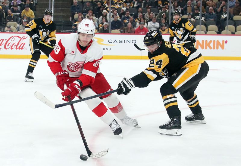 Nov 13, 2024; Pittsburgh, Pennsylvania, USA;  Detroit Red Wings right wing Patrick Kane (88) handles the puck against Pittsburgh Penguins defenseman Matt Grzelcyk (24) during the second period at PPG Paints Arena. Mandatory Credit: Charles LeClaire-Imagn Images