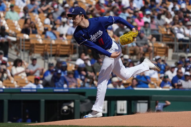 Mar 11, 2025; Phoenix, Arizona, USA; Los Angeles Dodgers pitcher Roki Sasaki (11) throws against the Cleveland Guardians in the first inning at Camelback Ranch-Glendale. Mandatory Credit: Rick Scuteri-Imagn Images