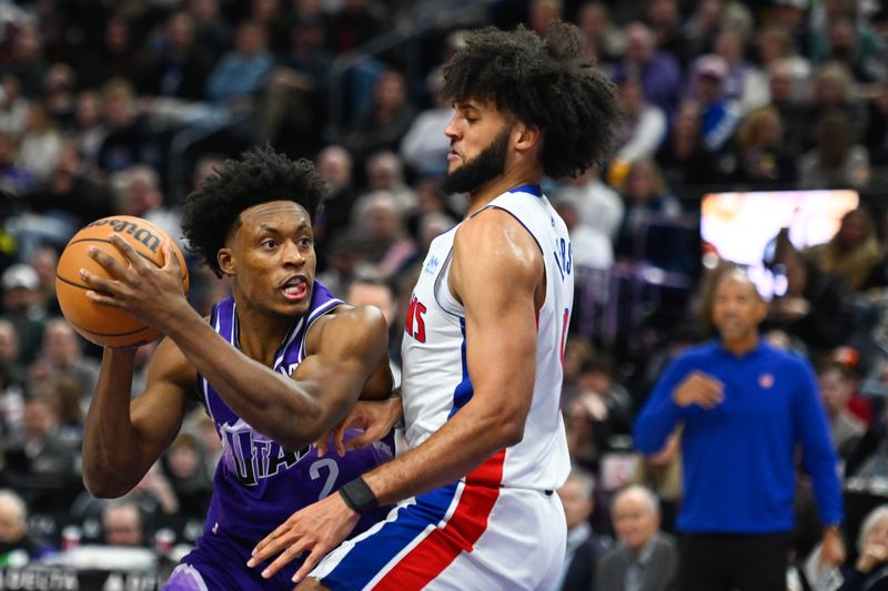 SALT LAKE CITY, UTAH - JANUARY 03: Collin Sexton #2 of the Utah Jazz looks for a pass against Isaiah Livers #12 of the Detroit Pistons during the first half of a game at Delta Center on January 03, 2024 in Salt Lake City, Utah. NOTE TO USER: User expressly acknowledges and agrees that, by downloading and or using this photograph, User is consenting to the terms and conditions of the Getty Images License Agreement. (Photo by Alex Goodlett/Getty Images)